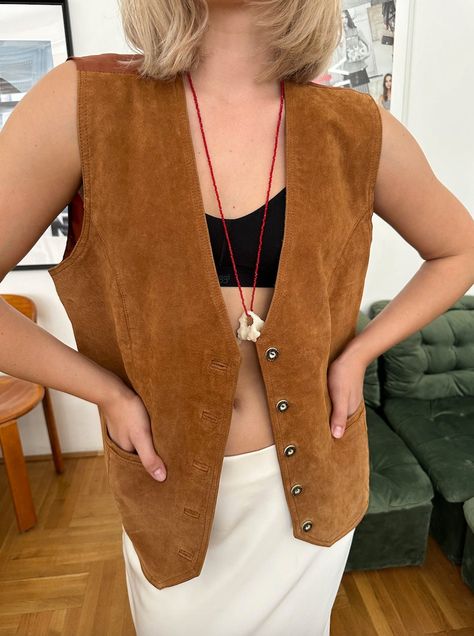 Vintage Brown Suede Leather Vest With Pockets  Material: Leather / Suede  Vintage condition level: good condition   MODEL is 5.3 ft 164 cm tall usually size S  Marked Siz: D46, NL46, GB20, F48 FLAT MEASUREMENTS (unstretched):  Length: 59 cm  Armpit to armpit: 56 cm  Shoulder to shoulder: 39 cm  Every item is vintage, pre-used, pre-loved, one-of-a-kind. All orders are final and sold as-is.  If you have any questions, please contact us before purchase. Irregularities or signs of wear might be pres Brown Suede Vest Outfit, Corduroy Vest Outfit, Suede Vest Outfit, Brown Vest Outfit, Leather Vest Outfit, Fall Vest Outfits, Loose Vest, Vest With Pockets, Brown Vest