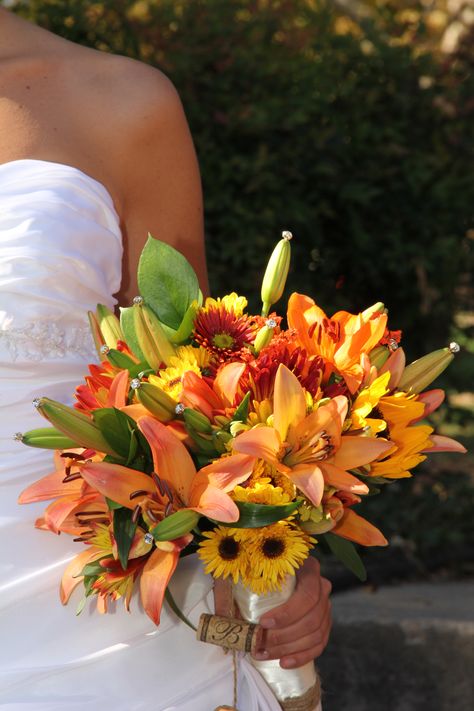 Fall bridal bouquet with orange Asiatic lilies, sunflowers, poms    www.upsydaisy.shutterfly.com Sunflower And Tiger Lily Bouquet, Orange Lily Bouquet, Crow Wedding, Tiger Lily Bouquet, Fall Bridal Bouquet, Upsy Daisy, Cosy Fireplace, Prom Bouquet, Brothers Wedding