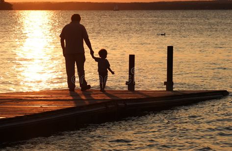 A Moment in Time. A father holds his son's hand as they walk out onto a dock at , #sponsored, #father, #holds, #Moment, #Time, #son #ad Father Holding Son, Writer Lifestyle, First Kid, Make Money Writing, Writing Career, A Moment In Time, Creative Icon, Walk Out, 24 Years Old