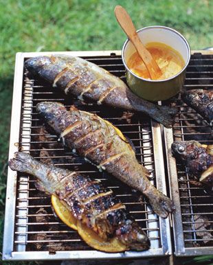 Grilled Striped Bass with Orange-Saffron Butter - Bon Appétit Saffron Butter, Bbq Fish, Grilled Fish Recipes, Seasoned Butter, Striped Bass, Grilled Fish, Sea Bass, On The Grill, Butter Recipe