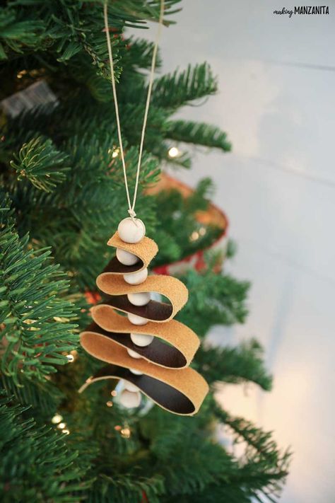 These DIY leather ornaments fit right in with the modern farmhouse home decor style and are such a great budget-friendly Christmas craft! This easy to follow tutorial will walk you through how to make this leather ornament that looks like a mini Christmas tree with wood beads. Diy Leather Ornaments, Leather Ornaments, Craft Ornaments, Boho Christmas Tree, Easy Christmas Ornaments, Christmas Crafts For Adults, Ornaments For Christmas, Easy Christmas Decorations, Leather Diy Crafts