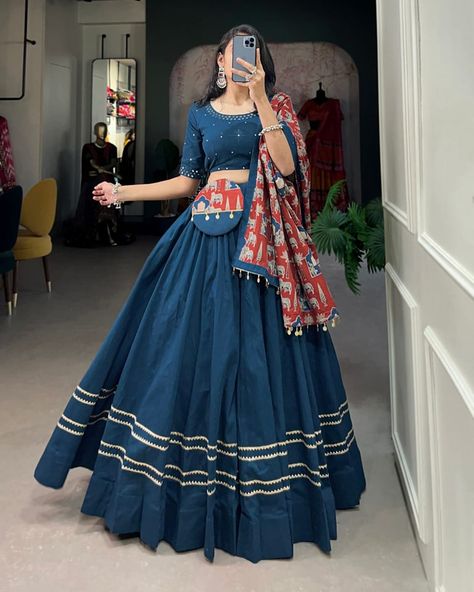 Dance through Navratri nights in this beautifully printed pure cotton lehenga choli. Complete with a matching purse and intricate coin lace detailing, it's perfect for the celebrations! 🥰 *Lehenga (Stitched)* Lehenga Fabric : reyon Cotton Lehenga Work : Plain With Gota Patti Touch Up Lehenga Waist : Support Up To 42 Lehenga Closer : Drawstring With Zip Stitching : Stitched With Canvas Length : 41 Flair : 6 -7 Meter Inner : Micro Cotton *Blouse (Unstitched)* Blouse Fabric : reyon Cotton ... Chaniya Choli Designs Navratri, Coin Lace, Cotton Lehenga Choli, Zip Stitching, Dress Designs For Stitching, Chaniya Choli Designs, Red Lehenga Choli, Rajputi Dress, Lehenga Saree Design