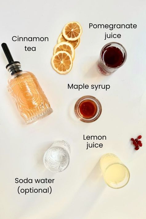 ingredient shot with elements needs to make the recipe including cinnamon tea maple syrup lemon juice soda water and pomegranate juice Non Alcoholic Mulled Wine, Non Alcoholic Sangria, Christmas Mocktails, Pomegranate Tea, Cinnamon Tea, Soda Water, Honey Syrup, Sangria Recipes, Mocktail Recipe