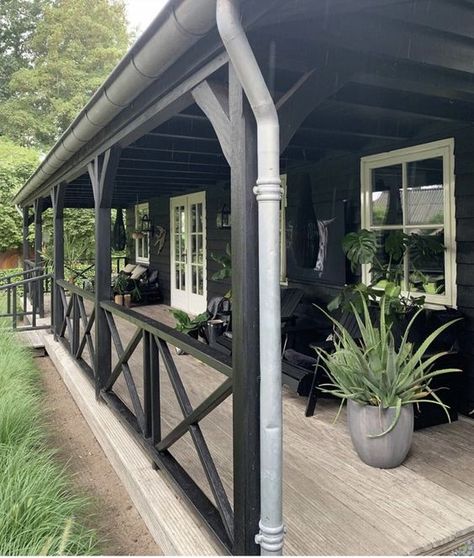 a Nordic porch with black wooden chairs, potted greenery and black loungers in the second part of the porch Scandinavian Porch, Pergola Outdoor Living, Bungalow Style, Front Patio, Casa Exterior, Home Porch, House With Porch, Porch Design, Interior Modern