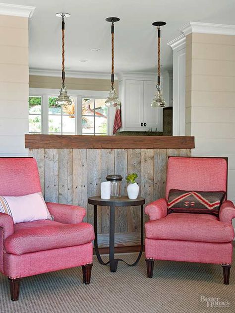 Reclaimed wood makes another appearance in the living room, highlighting the kitchen pass-through. A pair of plush pink upholstered chairs invite friends and family to take a seat and continue conversation./ Kitchen Pass Through To Living, Pass Through Kitchen To Living Room, Kitchen Living Rooms, Pass Through Kitchen, Modern Kitchen Room, Kitchen Pass Through, Kitchen Pass, Family Friendly Living Room, Condo Ideas