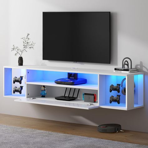 PRICES MAY VARY. 【FLOATING TV STAND WITH LED LIGHTS】This TV stand is 55" W x 11.8" D x 11.8" H with 20 changed LED lights. Who doesn't want to install such a cool LED TV stand at home?Whether you are playing games or watching TV , the blessing of cool lighting with the switch controlled will make your entertainment life more dynamic. 【WIRE ORGANIZED TV SHELF】The consoles have cable holes designed to hide messy cables. Keep your things organized and hanging entertaining enhances the living space. Bedroom Tv Wall Mount, Entertainment Center Organization, How To Hide Ps5, Kids Room Tv Unit Design, Playstation Setup Ideas, Gamer Room For Boys, Gaming Console Organization, Hanging Tv Ideas Living Room, Living Room Tv Ideas