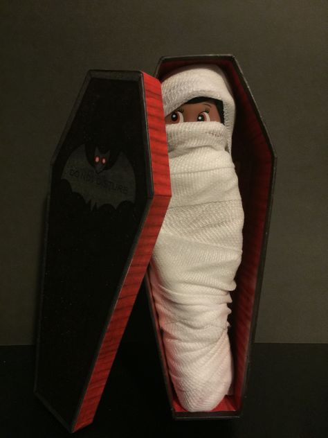 Elf on the shelf Halloween elf Wrapped in Gauze to look like a mummy and put in this little box coffin. The gauze and the coffin ( I chose the big one )were bought at the dollar store. I just folded the legs behind her at the knee and wrapped her up. Total cuteness for Halloween. Halloween Elf On The Shelf Ideas, Halloween Elf On The Shelf, Elf On The Shelf Halloween, Clown From It, Elf Halloween, Elf 2023, Elf Ideas Easy, Elf Games, Bad Elf