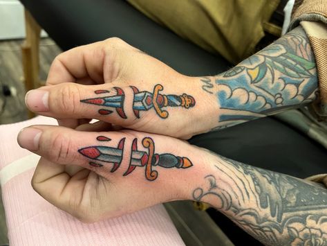 Small Matching Traditional Tattoos, American Traditional Thumb Tattoo, Sailor Hand Tattoo, Bowie Knife Tattoo Ideas, Traditional Thumb Tattoo, Finger Tattoos Traditional, Flower Thumb Tattoo, Traditional Tattoos Hand, Dagger Hand Tattoo