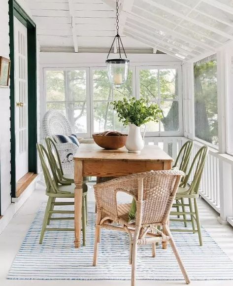 a lovely neutral screened porch with a stained table, green and neutral wicker chairs, some greenery   a cool dining space Green Screened In Porch, Whitewash Dining Table, Porch Design Ideas, Stained Table, Painted Wicker, Wicker Dining Chairs, Screened In Patio, Beach House Interior, Wicker Chairs