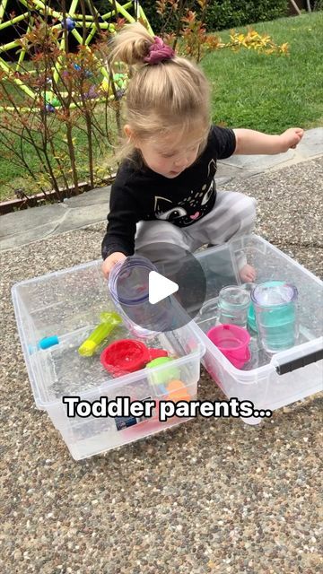 Brittany Bacharach on Instagram: "One of the greatest toddler activities is this one right here! Toddlers love to scoop and pour things, so make them a pouring station and sit back and watch the magic. We like to use big plastic storage containers to contain the water. Inside these containers I put an assortment of cups and bowls. You can also add measuring cups, spoons, or anything else you want to use for them to scoop and pour water! Then fill up the cups or one of the containers with water and let your toddler play! My only “rule” with this activity is the water stays inside the bins. If my toddler spills outside the bins by accident, I don’t care. But if they pour it outside of the bins on purpose, I remind them that water stays inside the bins and model what I mean. If it contin Pouring Station, Plastic Storage Containers, Plastic Container Storage, Parenting Toddlers, Toddler Play, Water Play, Water Activities, Educational Games, Sit Back