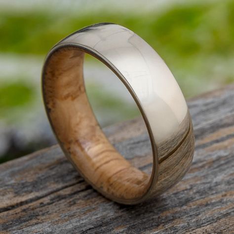 Stylish and natural, this oak wood wedding band features an inner wood sleeve and a polished 14k gold overlay. An oak wood sleeve is both sleek and stylish, as well as a comfortable material on the skin. This simple style of ring will outlast all of the trends.This wood wedding band comes with FREE Ring Armor Waterproofing (a $75 value).RING LAYOUT Ring Width: 7 mm Ring Sleeve: Oak Wood Ring Profile: Round Ring Finish: Polished7 mm 14k Gold OverlayThis ring has a comfort fit.RING FITTING:We high Wood Wedding Ring Mens, Ring Armor, Jewelry By Johan, Wood Wedding Band, Mens Gold Wedding Band, Solid Gold Ring, Wood Wedding, White Gold Wedding Bands, Wood Ring