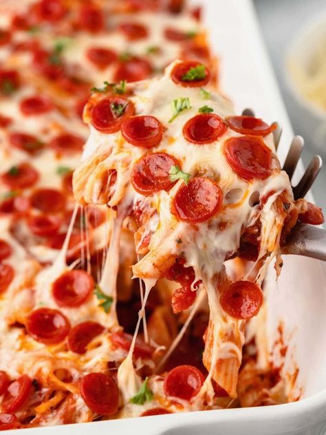 This Pepperoni Pizza Casserole recipe is a family favorite that's loaded with marinara sauce, mini pepperoni slices and two types of cheese! It's the perfect pizza bake for busy weeknights, and easy to personalize with your favorite pizza toppings. Pizza Caserole, Pepperoni Pizza Cake, Pepperoni Pizza Casserole Recipe, Pepperoni Pizza Casserole, Pizza Casserole Recipe, Pepperoni Pasta, Pizza Pasta Bake, Lasagna Casserole, Mini Casseroles