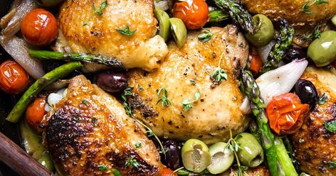 Baked Chicken Thighs With Asparagus | The Modern Proper Dutch Oven Chicken Recipes, Asparagus Chicken, Dutch Oven Chicken, Garlic Herb Chicken, The Modern Proper, Modern Proper, Oven Chicken Recipes, Dutch Oven Recipes, Roasted Cherry Tomatoes