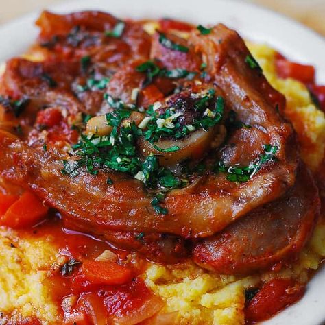 Authentic Italian Osso Bucco: veal shanks slowly braised with vegetables in tomato sauce and white wine until the meat falls of the bone.   Topped with another Italian classic: Gremolata (a condiment made with parsley, lemon zest, and garlic).  The veal shanks are served over creamy polenta or saffron risotto (Risotto Alla Milanese).   Osso Buco...Read More Best Osso Bucco Recipe, Oso Bucco Recipe, Shank Recipes, Veal Osso Bucco, Osso Bucco Recipe, Julia's Album, Osso Buco Recipe, Beef Shanks, Milanese Recipe