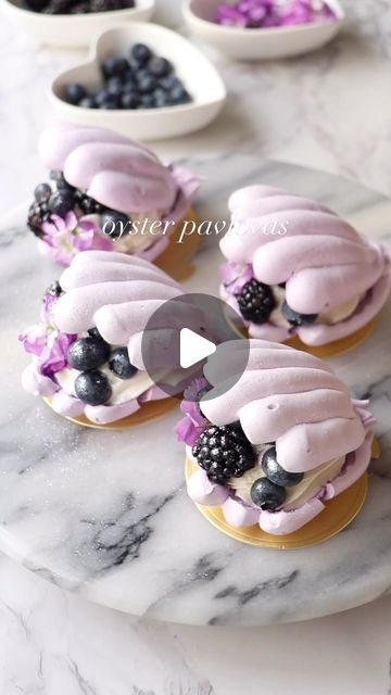 shelly bella on Instagram: "Oyster pavlovas for @thefeedfeed 🫐 I can’t handle them, soo dreamy! I used a silicone shell mold to pipe the meringue over so they would have a concave shape. I filled them with lemon curd, whipped cream, and topped with berries and edible flowers. My full pavlova recipe is on bellabakes.com -  Technique inspired by the brilliant @mamma_pavlova 🤍" Pavlova Recipe Mini, Meringue Desserts Ideas, Shell Pavlova, Pavlova Filling, Meringue Shapes, Winter Pavlova, Bday Treats, Pavlova Dessert, French Delicacies