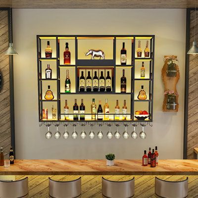 Williston Forge Joeziah Metal Wall Mounted Wine Bottle & Glass Rack in Black | Wayfair Small Bar Apartment, Wall Liquor Shelf, Bourbon Wall Display, Bar Unit Design, Wall Bar Ideas For Home, Home Bar Designs Small, Alcohol Stand, Wall Bar Ideas, Wall Bar Cabinet