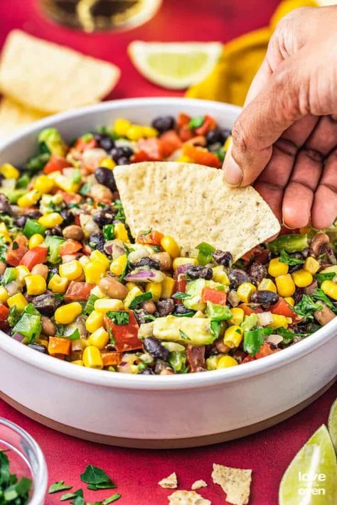 Cowboy Caviar is a vibrant veggie dip that's sure to impress anyone who tries it! This popular dip can be made in under 15 minutes and is a great source of nutrients without sacrificing flavor Easy Cowboy Caviar, Appetizers And Dips, Cowboy Caviar Dip, Appetizers For A Party, Popular Dips, Carrot Raisin Salad, Summer Appetizers, Summer Appetizers Easy, Delicious Veggies