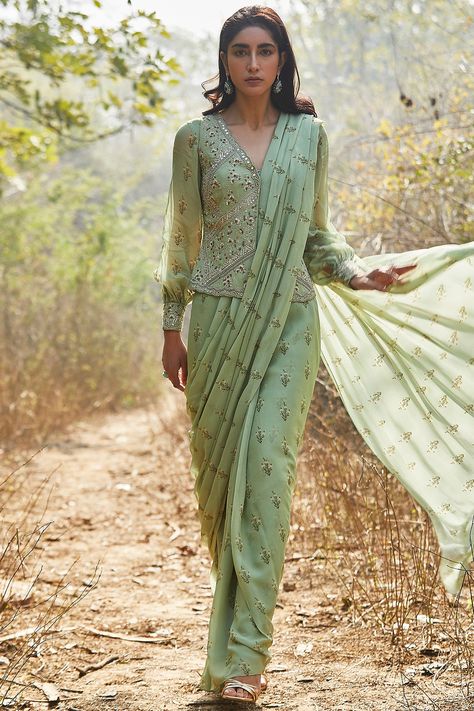 Featuring a mint pre-stitched saree in georgette base with sequins, zari, dabka, cutdana, and moti hand embroidery including lily print. It is paired with a matching jacket and a blouse having balloon sleeves. This contains only three pieces.     FIT: Fitted at bust and waist.  COMPOSITION: Georgette.  CARE: Dry clean only. Mint Green Fabric, Saree Jackets, Long Blouse Designs, Stitched Saree, Saree Blouse Patterns, Drape Saree, Designer Saree Blouse Patterns, Balloon Sleeve Blouse, Sari Blouse