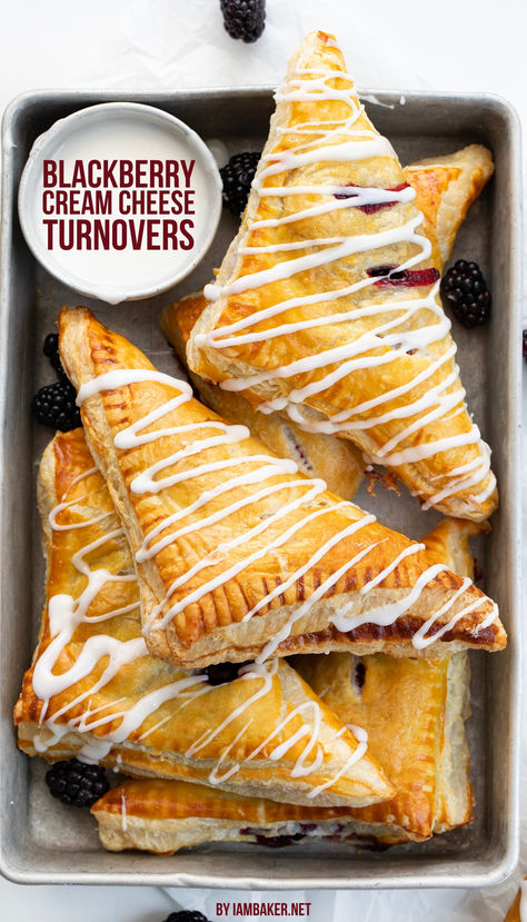 A silver pan is full of many blackberry turnovers and a small cup of glaze, on a white countertop. Cream Cheese Turnovers, Blackberry Cream Cheese, Puff Pastry Squares, Cheese Turnovers, Pastry Squares, Cream Cheese Puffs, Easy Impressive Dessert, Cream Cheese Puff Pastry, Blackberry Dessert