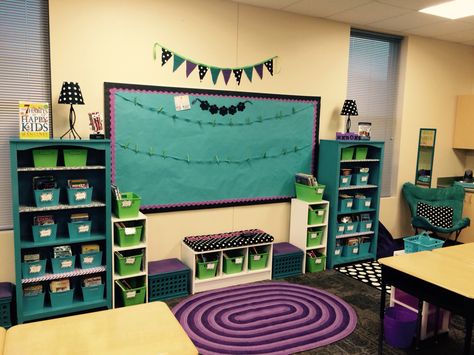 Classroom library, pride bulletin board, purple rug, polka dot lamps Classroom Decor Purple, Peacock Classroom Theme, Purple Classroom, Purple Classroom Theme, Purple Classroom Decor, Classroom Images, Classroom Decor Middle, Middle School Classroom Decor, Classroom Arrangement