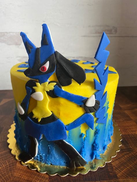 A 6” vanilla cake filled and covered in vanilla buttercream, decorated with a handcut Lucario figure! Pokemon Birthday Cake Lucario, Lucario Birthday Cake, Pokemon Cake Ideas Buttercream, Lucario Cake, Pokemon Cake Ideas, Pokémon Cakes, Pokemon Torte, Cake Pokemon, Pokémon Cake