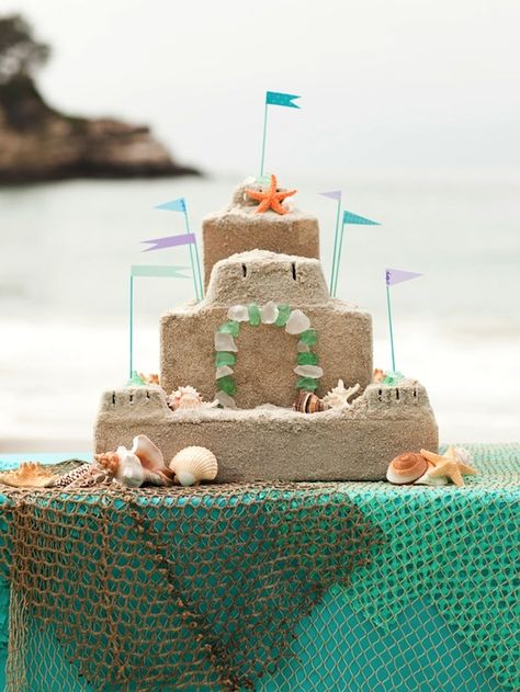 Live by the beach or want to pretend you do for your beach party? Create a DIY mod podge sand castle like this for a charming decoration #luau #beach #party Sand Castle Cakes, Beach Cupcakes, Castle Cake, Mermaid Theme Party, Beach Themed Party, Mermaid Parties, Under The Sea Theme, Beach Birthday, Mermaid Theme