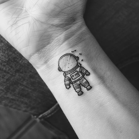 Embrace the universe on your skin with this minimalist astronaut tattoo, a symbol of adventure and the vastness of human curiosity. Save this cosmic inspiration and follow for more celestial wonders. This delicate ink captures the explorer within us all, nudging us towards the stars. Perfect for those who dream of interstellar journeys and the mysteries beyond our world. 🚀✨ #SpaceTattoo #MinimalistInk #AstronautArt #CelestialBeauty #InkInspiration #AI Astronaut Sitting On Moon Tattoo, Spaceman Tattoo Simple, Astronaut Tattoo Minimalist, Interstellar Tattoo Minimalist, Walter Mitty Tattoo, Simple Astronaut Tattoo, Small Astronaut Tattoo, Astronaut Tattoo Design, Spaceman Tattoo