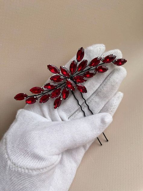 Looking for the perfect finishing touch for your bridal ensemble? Our exquisite black red hair pin is the ideal choice. Crafted with meticulous attention to detail, this bridal hair piece boasts a universal size, ensuring it complements any hairstyle effortlessly. Measuring approximately 4 inches in width, this elegant red hair accessory offers just the right amount of sparkle without overwhelming your look. Fashioned from luxurious crystal dark red rhinestones and intricately woven black jewelr Black And Red Accessories, Red Hair Piece, Red Bridal Hair, Red Hair Pieces, Black Headpiece, Red Hair Accessories, Wedding Hair Pin, Black Red Hair, Bridal Hair Pin