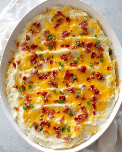 Loaded Mashed Potatoes are creamy and full of everything you would find in a baked potato. Bacon, sour cream, and cheese are in this yummy casserole. #mashed #potatoes #loaded Sides For A Crowd, Baked Potatoes Casserole, Holiday Dinner Sides, Casserole Thanksgiving, Potatoes Loaded, Loaded Mashed Potato Casserole, Twice Baked Potato Casserole, Potatoes Casserole, Parmesan Potato