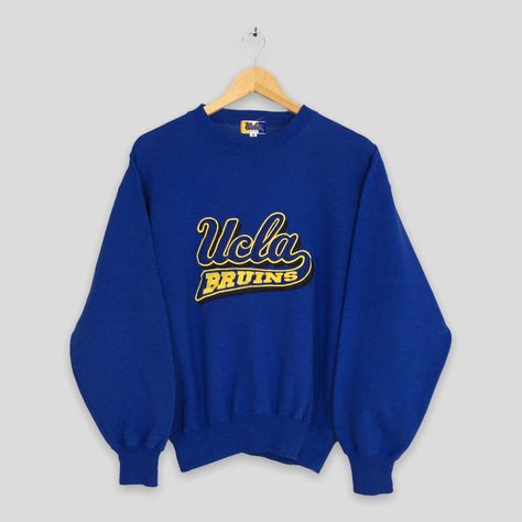 "Vintage 1990s UCLA Bruins Ncaa Sweatshirt Small University Of California Los Angeles Jumper Ucla California Crewneck Bruins Sweater Size S ▼ C O N D I T I O N : Good condition. No holes and stains. ▼ S I Z E (on tag) : Size S. To make sure if it FITS YOU, refer at the exact measurements. ▼ M E A S U R E M E N T S (flat) : ARMPIT (from pit to pit)                    : 21\" inches LENGTH (from back collar to hem) : 23\" inches WEIGHT                                                : 0.44 kg ▼ S H I P P I N G : DHL EXPRESS / EXPEDITED : 3-5 business day. **SHIP BY DHL EXPRESS, IT TAKES 3-5 BUSINESS DAYS TO ARRIVED. PLEASE LEAVE YOUR PHONE NUMBER ON THE NOTE WHEN PURCHASED.**  REF : Z-26032023-3375" Ucla Logo, Small University, Jumper Embroidery, Leroy Neiman, Fancy Stuff, California Los Angeles, Dream College, Vintage University, Ucla Bruins