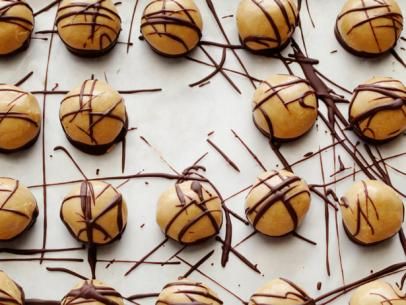 Frozen Peanut Butter Bites Recipe | The Neelys | Food Network Frozen Peanut Butter, Butter Bites, Peanut Butter Bites, Butter Balls, Peanut Butter Balls, Chocolate Peanuts, Creamy Peanut Butter, Frozen Desserts, Yummy Desserts