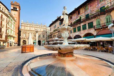 1ST Piazza delle Erbe (Herb Square) is Verona’s main town square, around 10-minutes’ taxi ride from the Porta Nuova train station. sense of Verona’s historic charm and town life, with its centerpiece 14th-century Madonna statue and fountain surrounded by old multi-storeyed buildings. Several osterias and bars line the square, some with terraces where you can enjoy people watching over coffee, beer or gelato. The piazza is also popular for shopping – check out the tented market stalls in Romeo Und Julia, Palermo Sicily, Italian Lakes, Verona Italy, Places In Italy, Venice Travel, Town Square, Lake Garda, Italy Vacation