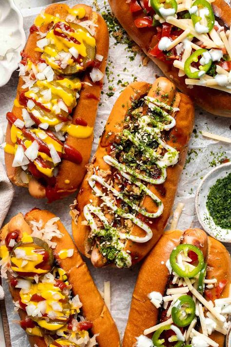 Juicy and delicious Gourmet Hot Dogs loaded with a variety of toppings will take your next backyard BBQ or potluck to a whole new level. Try them all! | aheadofthyme.com American Hot Dog Recipe, Fancy Hot Dogs Ideas, Gourmet Hotdogs Recipes, Loaded Hotdogs, Gormet Burgers, Hot Dog Toppings Ideas, Gourmet Hot Dog Bar, Fancy Hot Dogs, Gourmet Hot Dogs Toppings