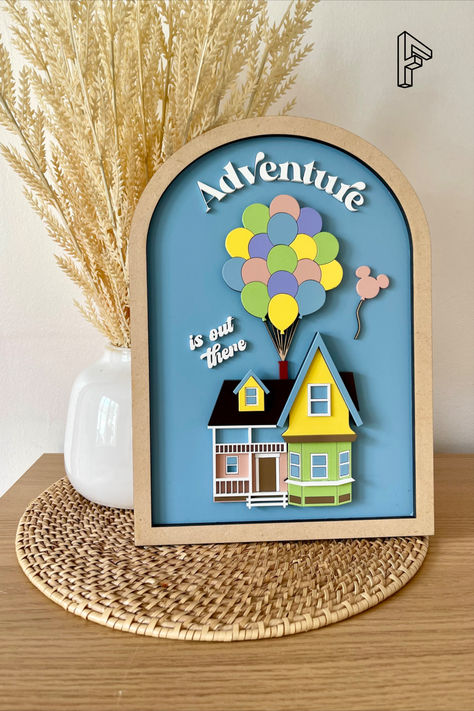 Add some Disney magic to your collection with this fun wood adventure is out there sign featuring the house from the movie Up. Measuring 12" x 8 1/2" x 1/2", this sign is a perfect addition to any home or office. Made of 1/8" MDF wood and featuring pastel colors, this sign is suitable for both kids and adults alike. The sign is inspired by the adventurous spirit of Carl and Ellie, making it a great gift for fans of all ages. Creative Photo Gifts, Diy Engagement Gifts, Carl And Ellie, Disney House, Up Pixar, Wood Laser Ideas, Up Movie, Movie Room Decor, Diy Laser Cut