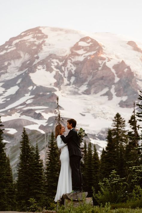 A couple in wedding attire stands on a log in front of Mount Rainier during their Mount Rainier elopement Mt Rainier National Park Wedding, Washington Elopement Photography, Spring Mountain Elopement, Mount Rainier National Park Elopement, Mount Rainier Engagement Photos, Mt Rainier Wedding, Mt Rainier Engagement Photos, Mount Rainier Wedding, Mount Rainier Elopement