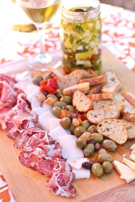 Tapas with marinated hatch chili and feta cheese Paella Birthday Party, Spanish Party Ideas, Spain Dinner Party, Spanish Theme Birthday Party, Spain Birthday Party Ideas, Paella Dinner Party Ideas, Spanish Hen Party, Paella Party Decorations Table Settings, Spanish Party Food