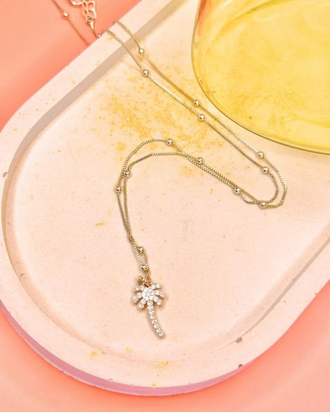 Channel tropical vibes with our Palm Tree Pendant Necklace.🌴✨ Featuring a dainty gold palm tree charm, this necklace adds a playful touch to your look, whether worn alone or layered with other pieces Grab this Palm Tree Pendant through the link in bio. #palmblush #tropicaljewlery #jewlery #sunshinejewlery #vacationjewlery #summervibes #hawaii #hawaii #palmtreenecklace Gold Palm Tree, Palm Tree Necklace, Palm Tree Pendant, Tree Pendant, Tropical Vibes, Palm Tree, Palm Trees, Link In Bio, Hawaii