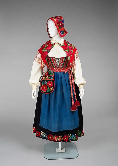 Ensemble, 1900–1915, Norwegian, wool, cotton, metal. This ensemble, known as a bunad represents the national dress of Norway. It is likely of the Rogaland variety, named for its district of origin. The form is based on traditions established in the 19th century. Bunads can be quite expensive due to the high quality of materials and craftsmanship in their construction. This example is evidence of this, especially in the handmade buttons and fine shirring of the skirt. Swedish Dress, Scandinavian Costume, Swedish Clothing, Embroidery Modern, Modern Folk, Folk Clothing, Unique Embroidery, National Dress, Folk Dresses