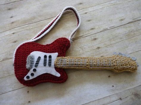 Crocheted guitar Crochet Guitar Bag, Crochet Instruments, Crochet Music, Crochet Presents, Guitar Patterns, Crochet Doll Dress, Crochet Keychain Pattern, Easy Crochet Stitches, Crochet Clothing And Accessories