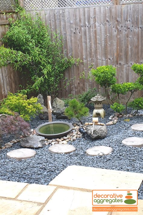 Slate Chippings are a very versatile aggregate. These grey slate chippings have been used for a gorgeous ground covering of an area that features lovely green shrubbery, rockeries, pebbles and a water feature. The dark rich grey tones of the slate chippings really bring to life the other features of this garden design. Black Slate Landscaping, Japanese Pebble Garden, Slate Gravel Garden Ideas, Grey Gravel Garden Ideas, Grey Slate Garden Chippings, Small Garden Water Feature Ideas, Slate Front Garden, Garden Slate Ideas, Slate Chippings Garden Ideas