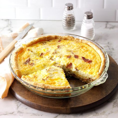 Breakfast Quiche Recipe -I enjoy preparing hearty country breakfasts for the guests at my bed-and-breakfast. This fluffy golden pie, which has lots of cheese and bacon, is a most satisfying entree.—Mark Clark, Twin Mountain, New Hampshire Breakfast Quiche Recipes Easy, Best Quiche Recipes, Bacon And Cheese Quiche, Christmas Breakfast Casserole, Quiche Lorraine Recipe, Breakfast Quiche Recipes, Quiche Recipes Easy, Cheese Quiche, Breakfast Quiche