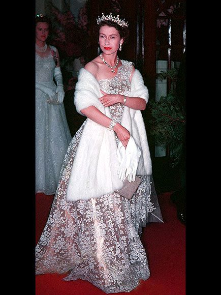 Queen Elizabeth in high style, her shimmering rose gold one-shoulder gown with floral embroidery, plus a striking tiara and white fur, embodied regal glamour. Young Queen Elizabeth, Rainha Elizabeth Ii, Reine Elizabeth Ii, Reine Elizabeth, Mode Chanel, Elisabeth Ii, Reina Isabel Ii, Royal Queen, Tilda Swinton