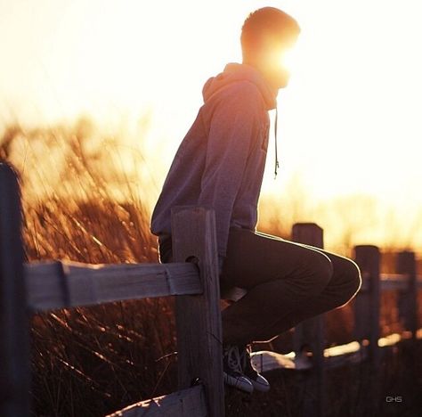 Boy sitting on a fence Sky Tutorial, Sitting On Fence, Rock Fence, Portrait Lighting, Pose Idea, Man Sitting, Person Sitting, People Sitting, Women Rising