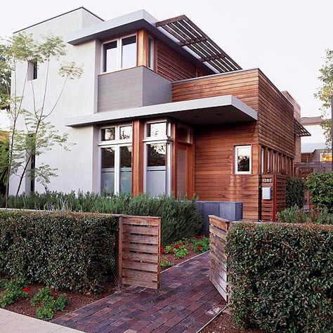 Stained wood siding adds warmth to this modern facade. More exterior color schemes: http://www.bhg.com/home-improvement/exteriors/curb-appeal/best-exterior-house-color-schemes/?socsrc=bhgpin040813woodsiding=6 House Siding Options, Renovation Facade, Gray House, Plans Architecture, Exterior House Color, Exterior Modern, Exterior Color Schemes, House Color Schemes, Exterior Paint Colors For House