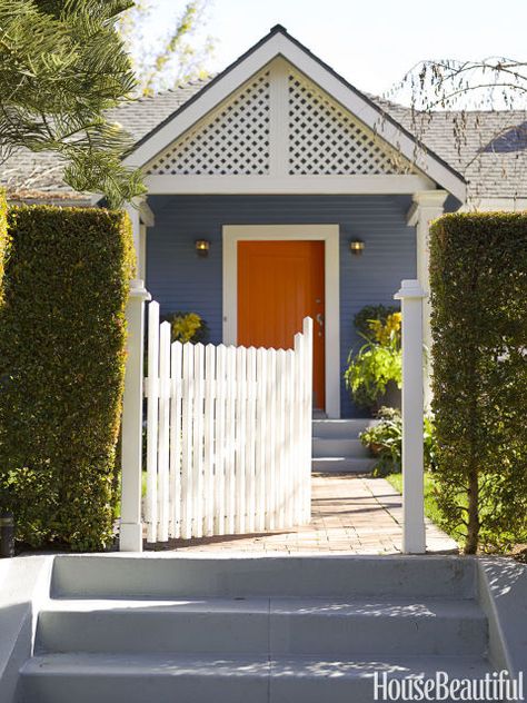 AND ON A FRONT DOOR: ORANGE – Orange, white, and blue are the colors Moises Esquenazi used repeatedly inside and outside his Los Angeles house, beginning at the entry — which he designed to be "chic and dramatic." Red tip hedges give the bungalow more privacy. Click for the full gallery and for more front doors. Orange Front Doors, Front Door Inspiration, Best Front Doors, Orange Door, Front Door Paint Colors, Door Paint Colors, Door Inspiration, Painted Front Doors, Front Door Colors