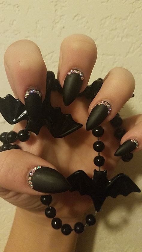 Black gel matte short stelleto with rhinestones along cuticle. Black Oval Nails With Rhinestones, Black Nails With Rhinestones, Nails With Rhinestones, Black Gems, Gem Nails, Rhinestone Nails, Black Nails, Ear Cuff, Nail Art