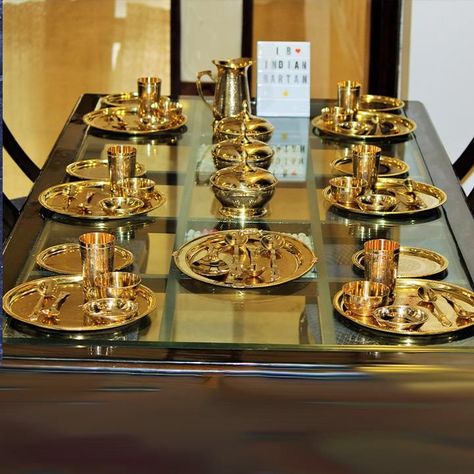 Buy a traditional Brass royal dinner set from Indian Bartan. The 6 Person Royal Brass Dinner Set is made in India with brass. It includes 6 Full Plates,6 Half Plates,6 Glasses,6 Bowls,6 Dish Plates,3 Serving Bowls with lid,1 Rice Plate,1 Jug,12 Spoons,3 Serving Spoons. Indian Kitchen Utensils, Royal Dinner, Vintage Kitchen Gadgets, Dinnerware Set Modern, Serving Bowls With Lids, Crockery Design, Modern Kitchen Storage, Kitchenware Products, Copper Utensils