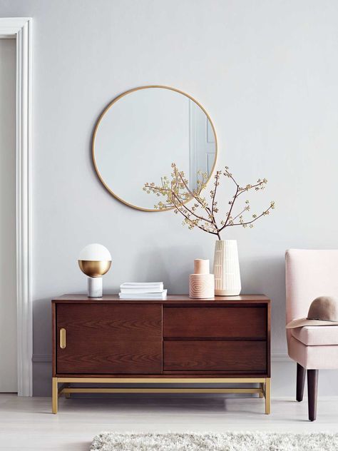 Modern sideboard and round mirror with blush slipper chair from Project 62 on Thou Swell @thouswellblog Hm Home, Target Home Decor, Mirror On The Wall, Affordable Decor, H&m Home, Retro Home Decor, Round Mirror, Retro Home, Architectural Digest