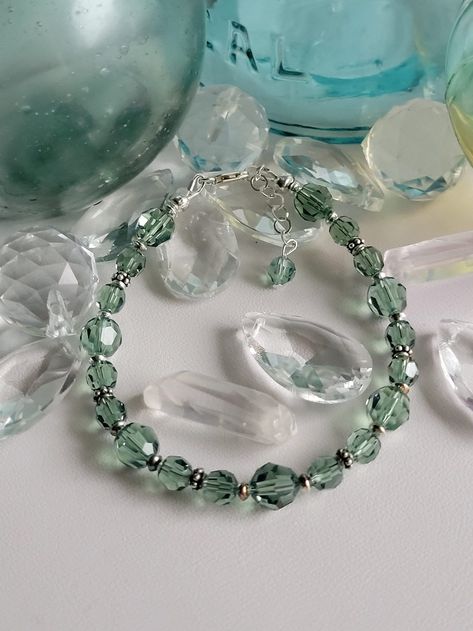 "This beautiful set is made with Erinite green (light green) 6mm/8mm round Swarovski crystal. The remainder of the beads and the findings are sterling silver. This bracelet has a 1\" extension with a beaded drop making it adjustable. The dangle earrings feature sterling silver lever back ear wires.  Custom Orders are always welcome! Most bracelets can be sized for free upon request." Silver Crystal Bracelet, Polymer Clay Jewelry Diy, Swarovski Beads, Sterling Bracelets, Clay Jewelry Diy, Handmade Wire Jewelry, Green Light, Pretty Jewellery, Polymer Clay Jewelry