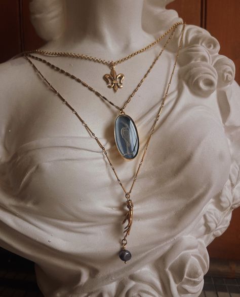 Elegant and a touch dramatic, this layered look focuses on the Ardea Heron Pendant—one of our newest pieces hand-painted with blue enamel over a soft, white heron framed in gold. Above lies the Fleur-de-Lis from our flagship Bonaparte collection, and at the bottom a Forbidden Fruit Charm inspired by Hades and Persephone. ⁠ ⁠ In a word? Perfection. White Heron, Forbidden Fruit, Hades And Persephone, A Word, Layered Look, Soft White, Hand Painted, Fruit, Pendant